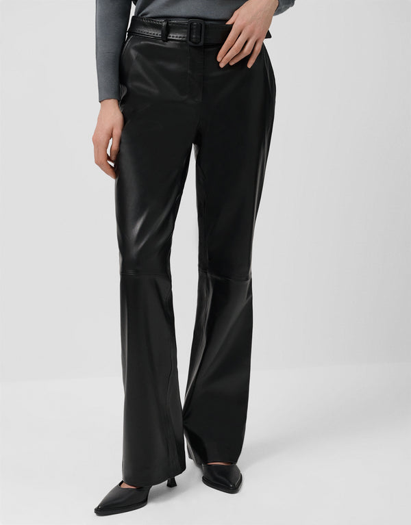 Person wearing black wide-leg pants on a light gray background