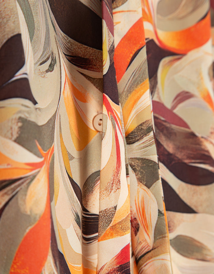 Close-up of a colorful patterned fabric with swirls and abstract designs.