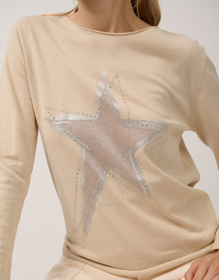 Beige sweater with a large star design on a plain background