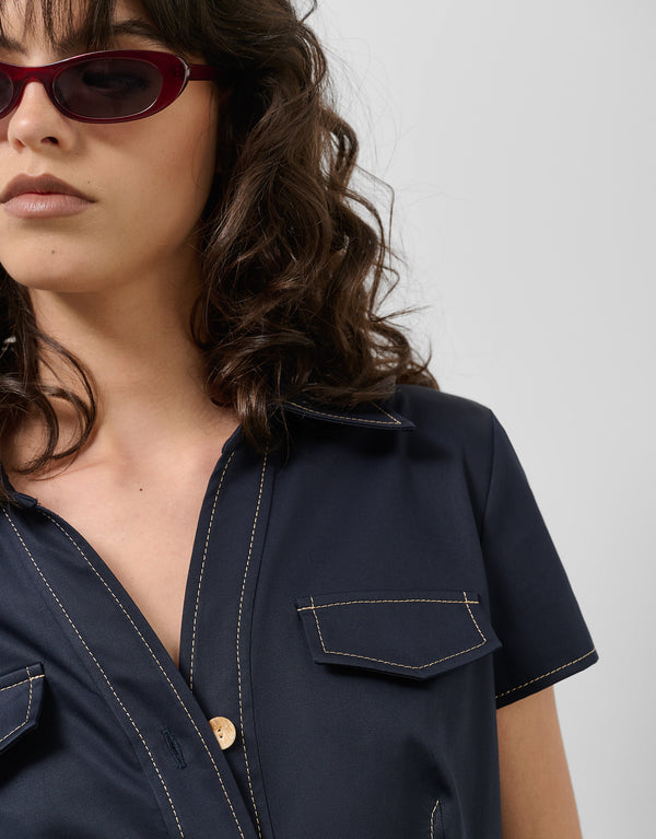 Navy blue shirtwaist dress with short sleeves and beige backstitching