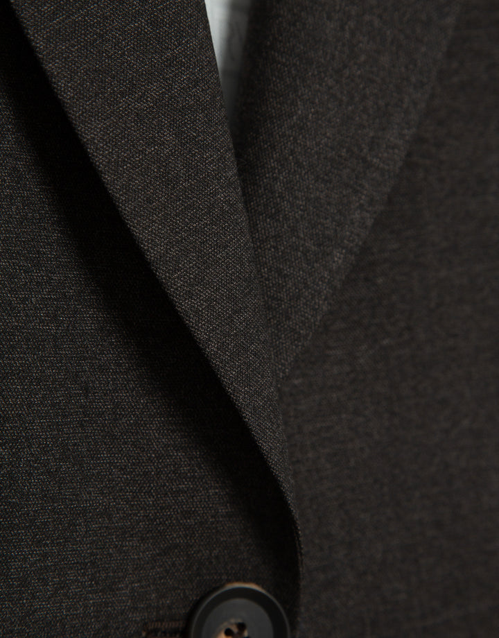 Close-up of a dark gray textured fabric with a button