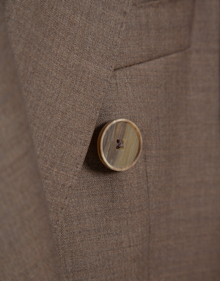 Close-up of a brown textured fabric with a button