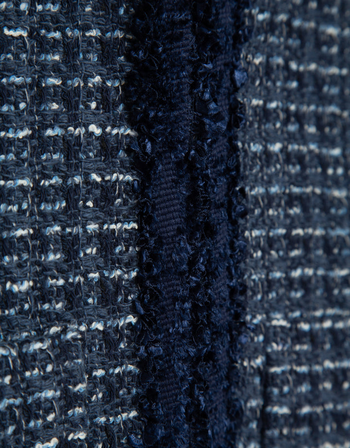 Close-up of a textured dark blue fabric with a subtle pattern
