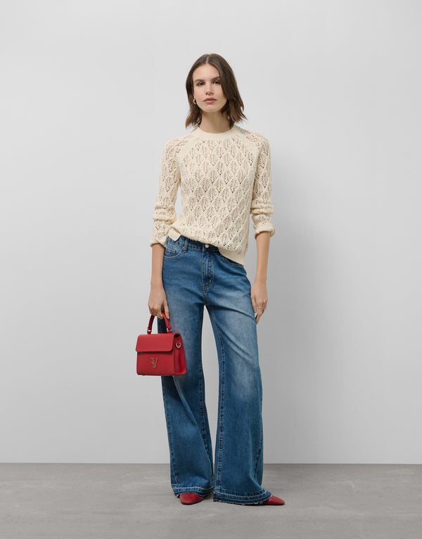 Cream knit sweater with long sleeves and a diamond design
