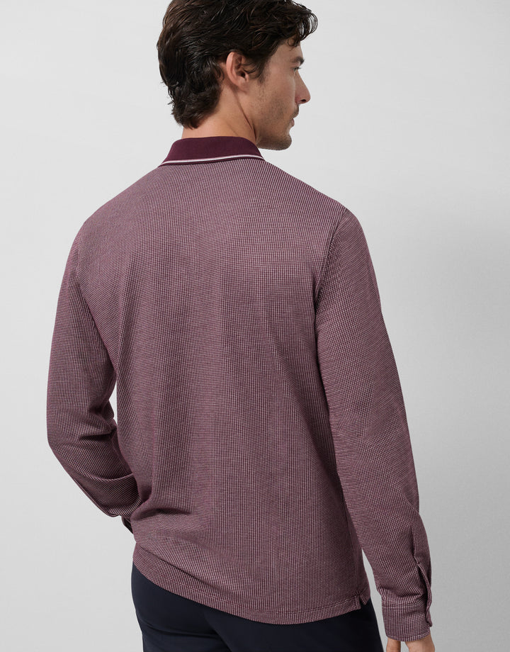 Man wearing a purple textured sweater against a light gray background
