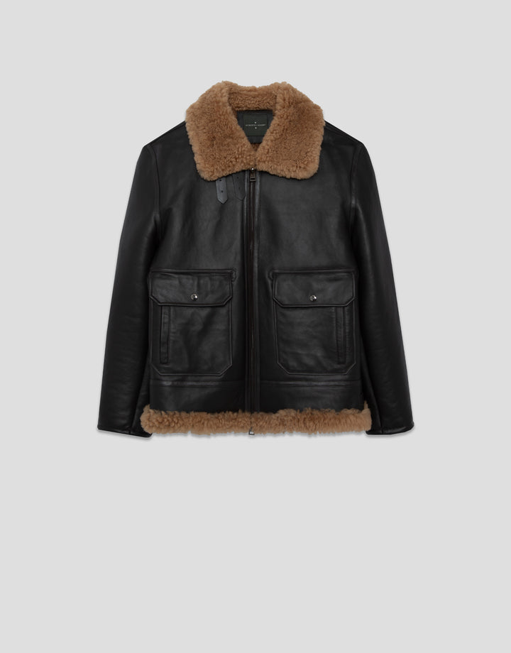 Black leather jacket with brown fur collar and trim on a light gray background