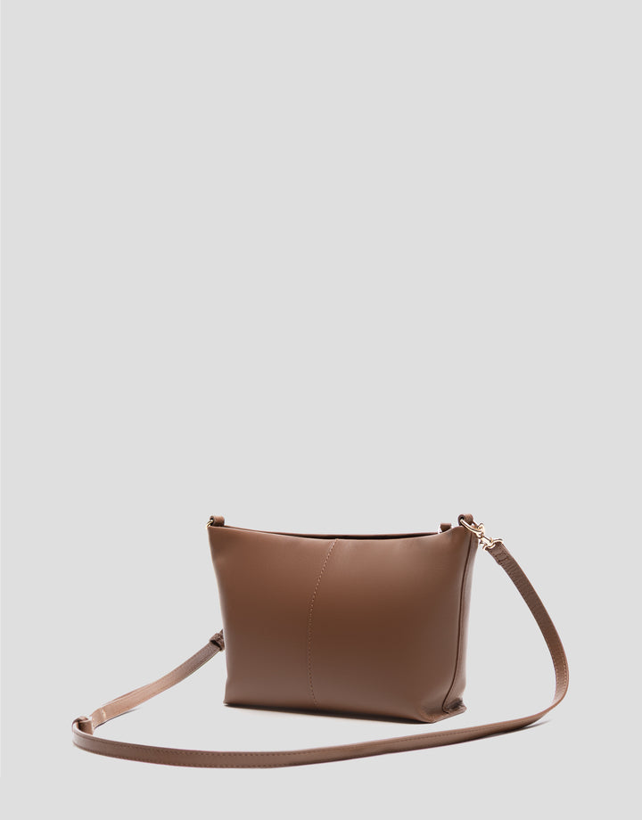 Brown leather handbag on a light gray background
