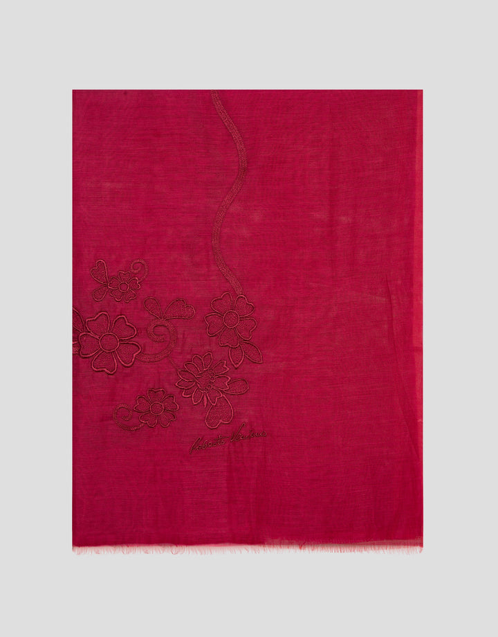 Red scarf with floral embroidery on a light gray background