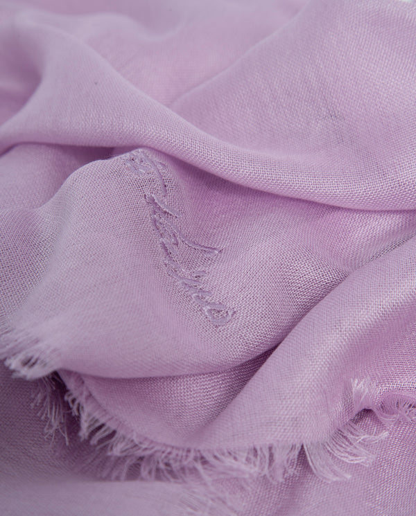 Close-up of a soft purple fabric with frayed edges