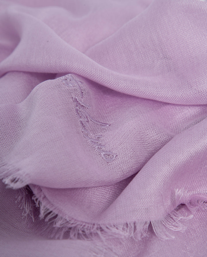 Close-up of a soft purple fabric with frayed edges