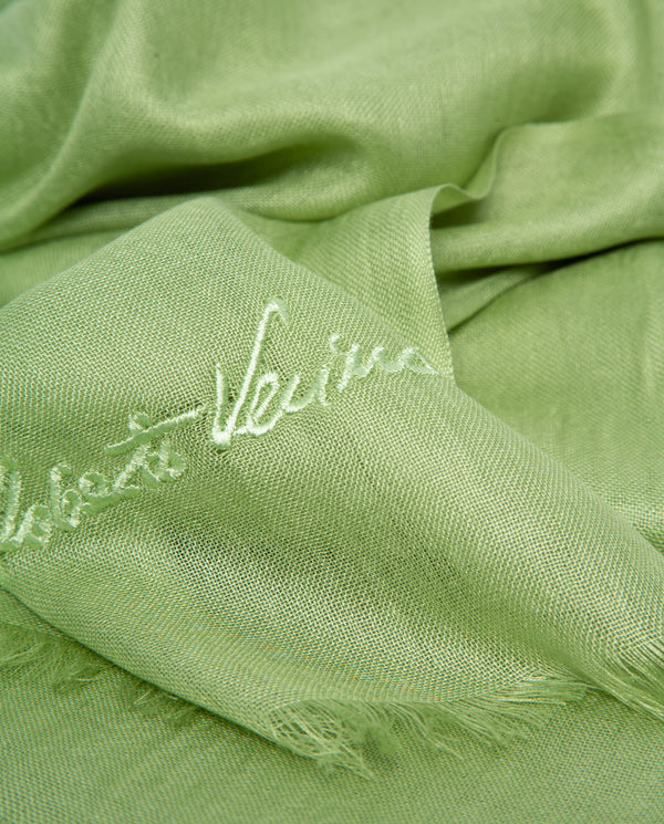 Green fabric with 'Louis Vuitton' embroidery