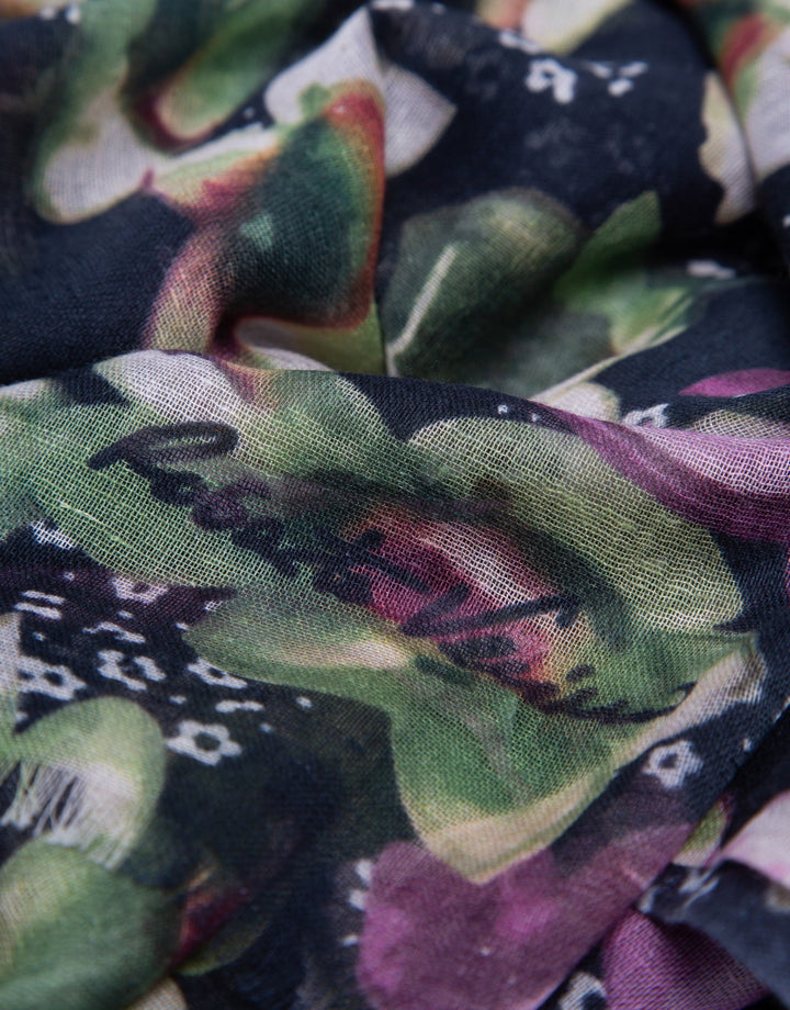 Close-up of a colorful fabric with floral patterns and text.