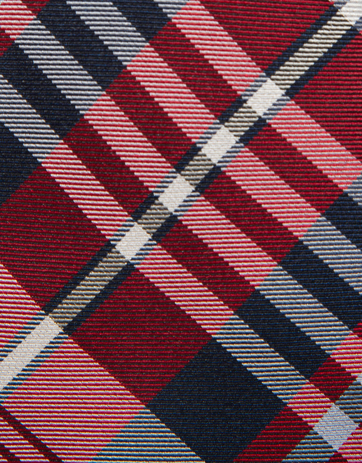 Close-up of a plaid fabric with brown, blue, and white colors.