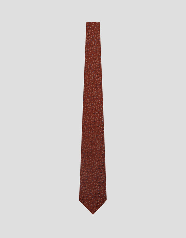 Brown patterned tie on a light gray background